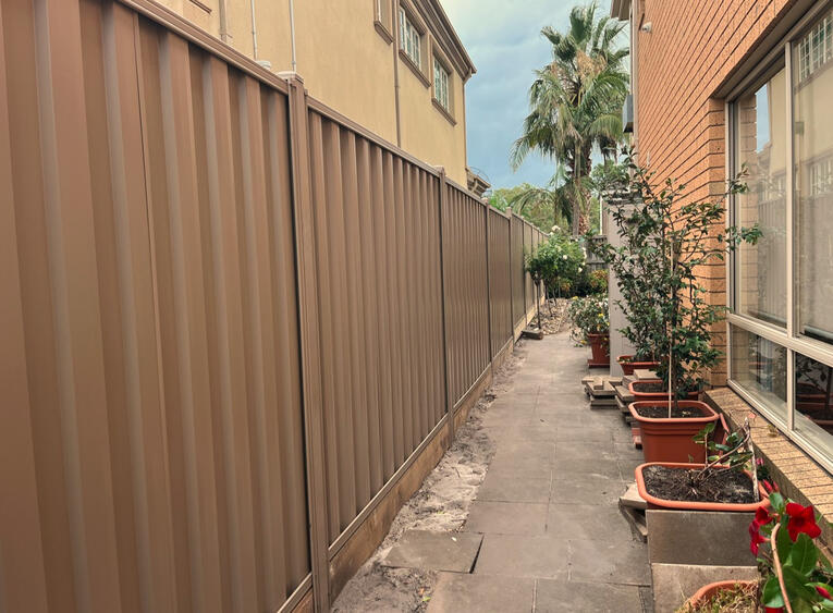 Colorbond fence with reinforced posts Riversand colour installed in Dandenong